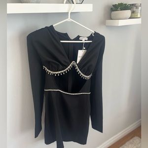 black dress with silver metal details and open front.